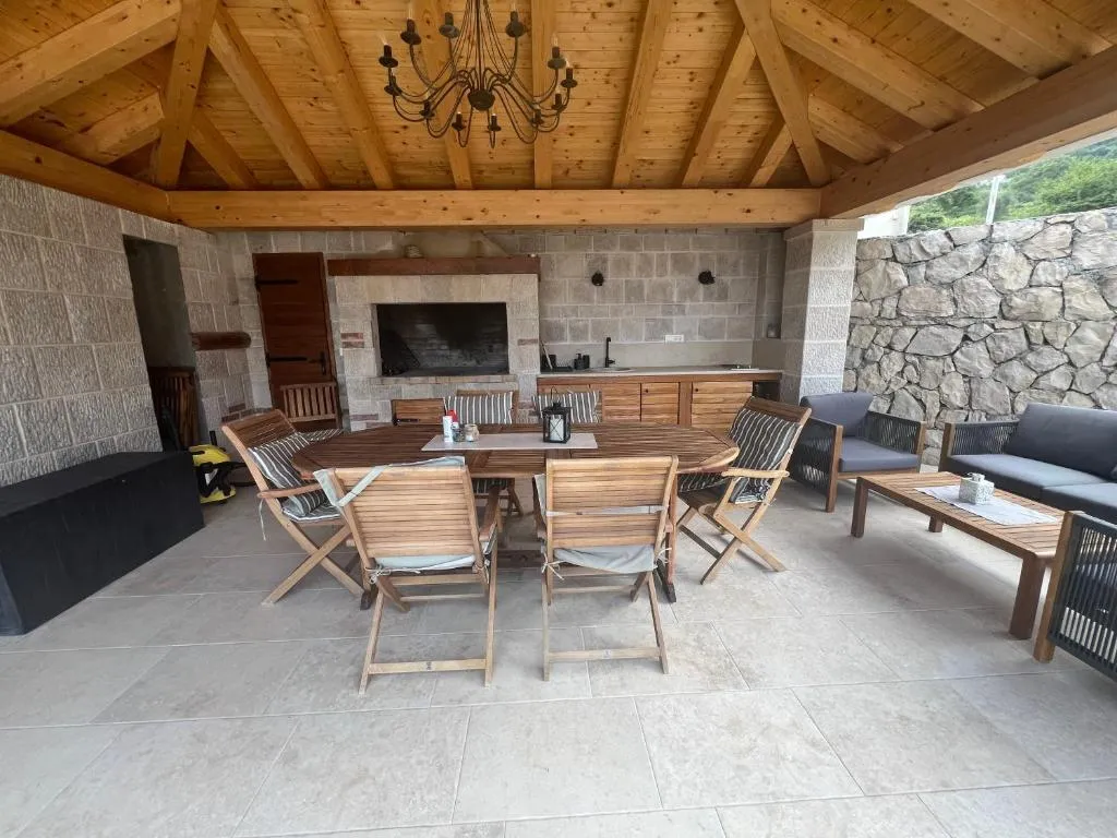 The villa's new stone glorijet with outdoor summer kitchen and dining table