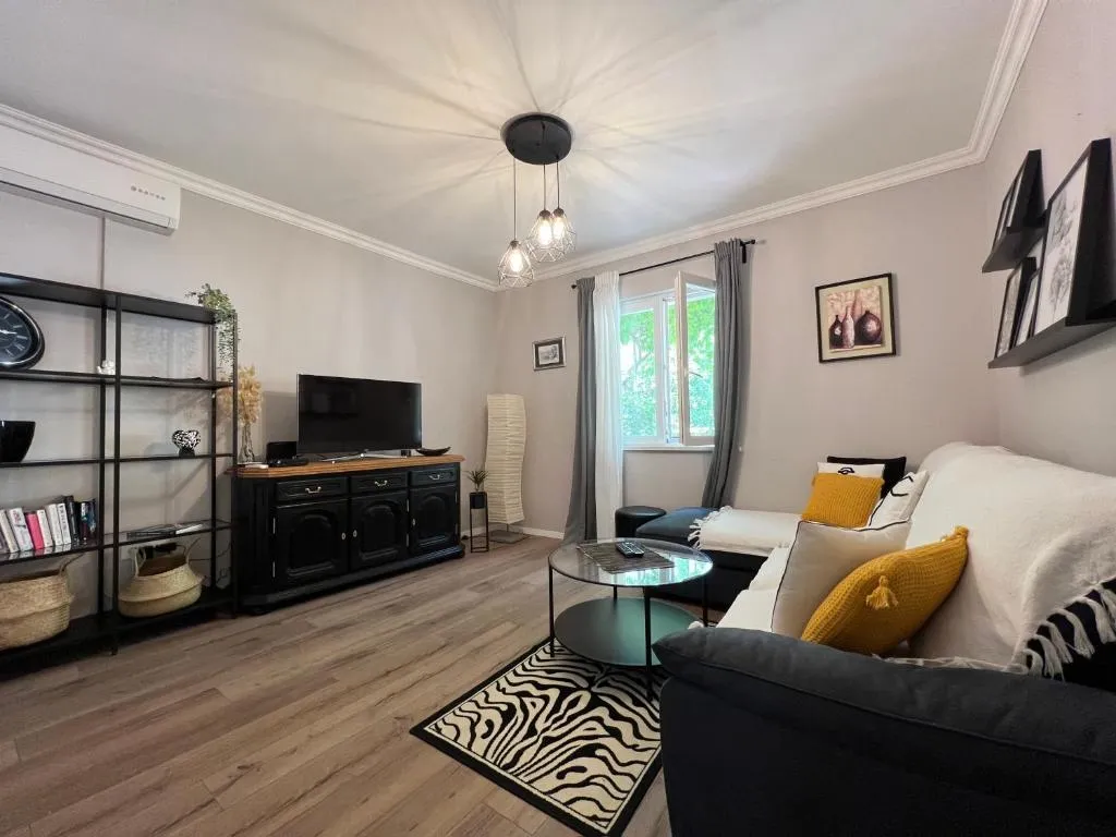 Living room at Villa Betty with sofa and TV