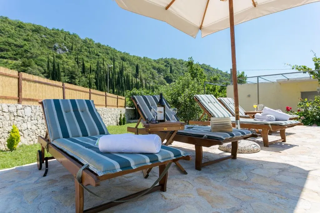 Poolside loungers with wine and a view of the Konavle hills